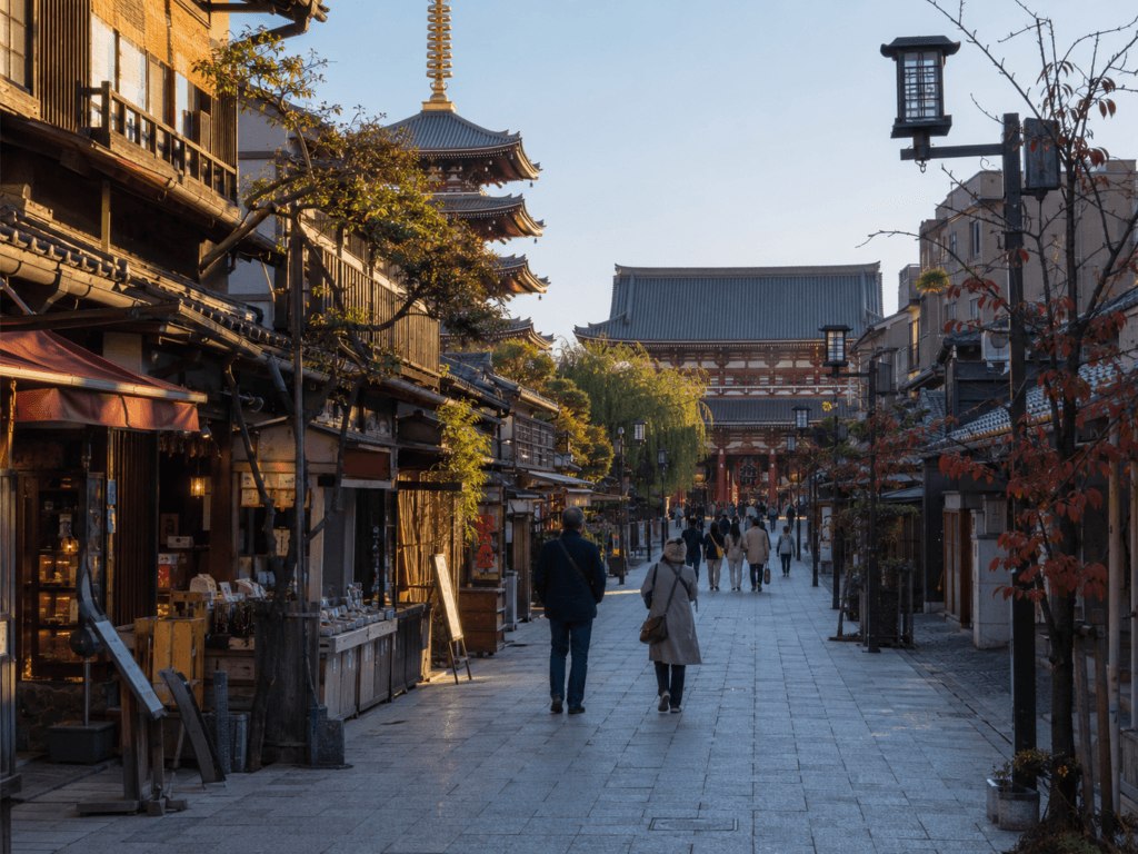 Asakusa old Tokyo street with traditional shops, temple buildings, pagoda and warm morning light