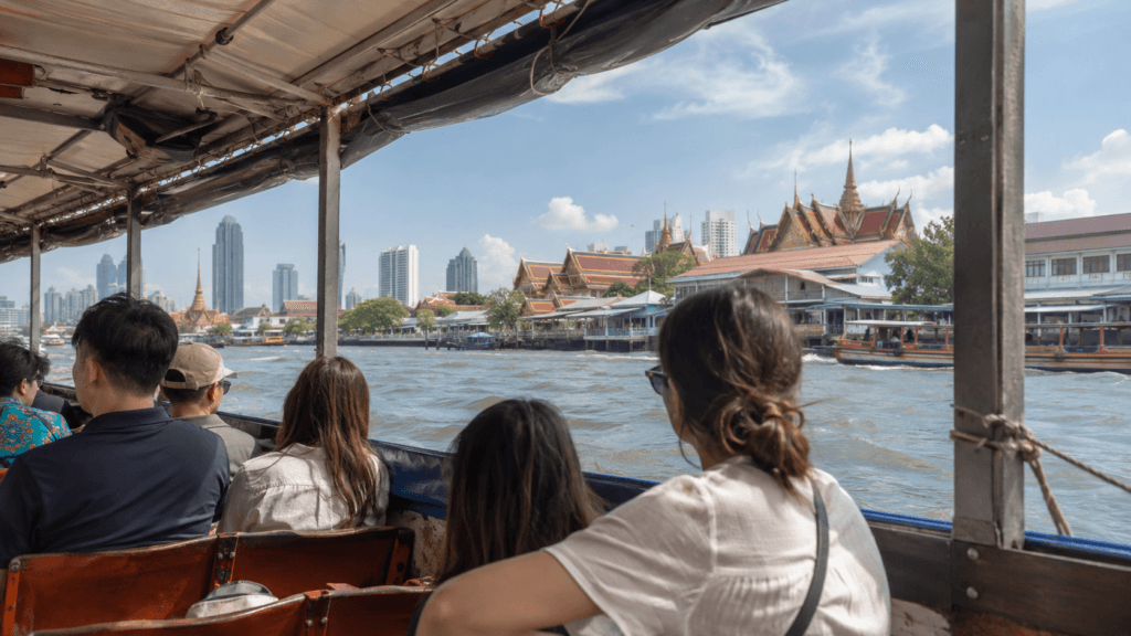 Travelers riding a local boat along the Chao Phraya River in Bangkok