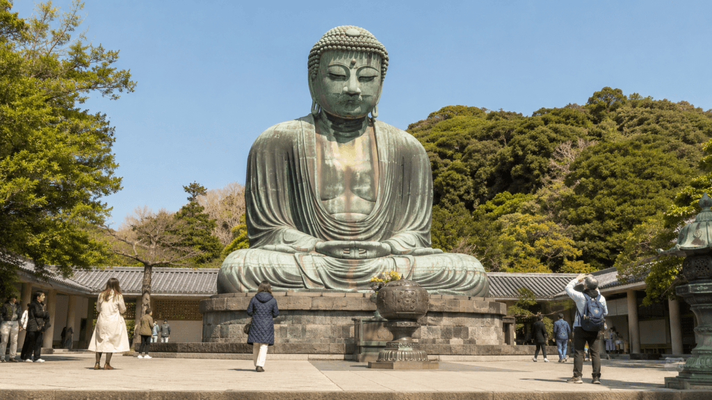 Visitors viewing the Great Buddha of Kamakura on a clear day