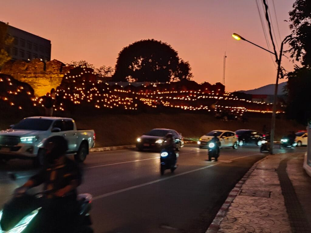 Candles glowing along Chiang Mai's old city wall on the eve of Yi Peng in November 2024