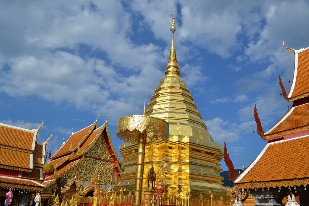 The golden chedi of Wat Phra That Doi Suthep beneath a blue Chiang Mai sky
