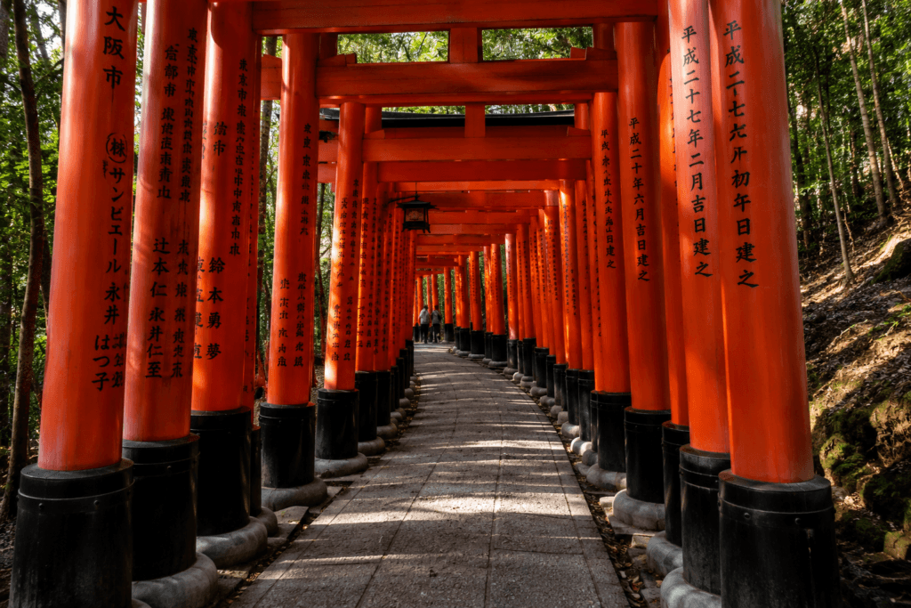 Fushimi Inari torii gates in Kyoto forming a quiet red shrine path through the forest