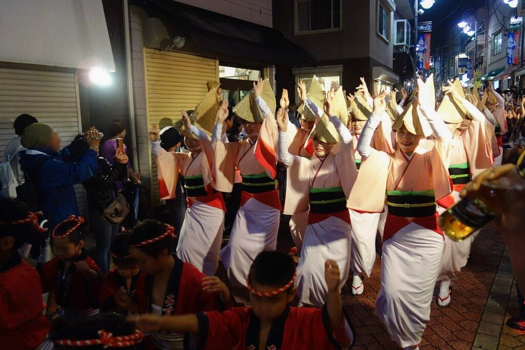 Awa Odori dancers performing on a crowded Koenji street at night in 2015