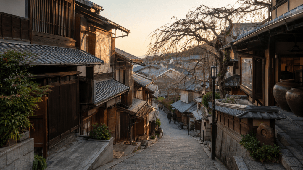 Quiet stone-paved street in Higashiyama Kyoto with traditional wooden buildings near Kiyomizu-dera