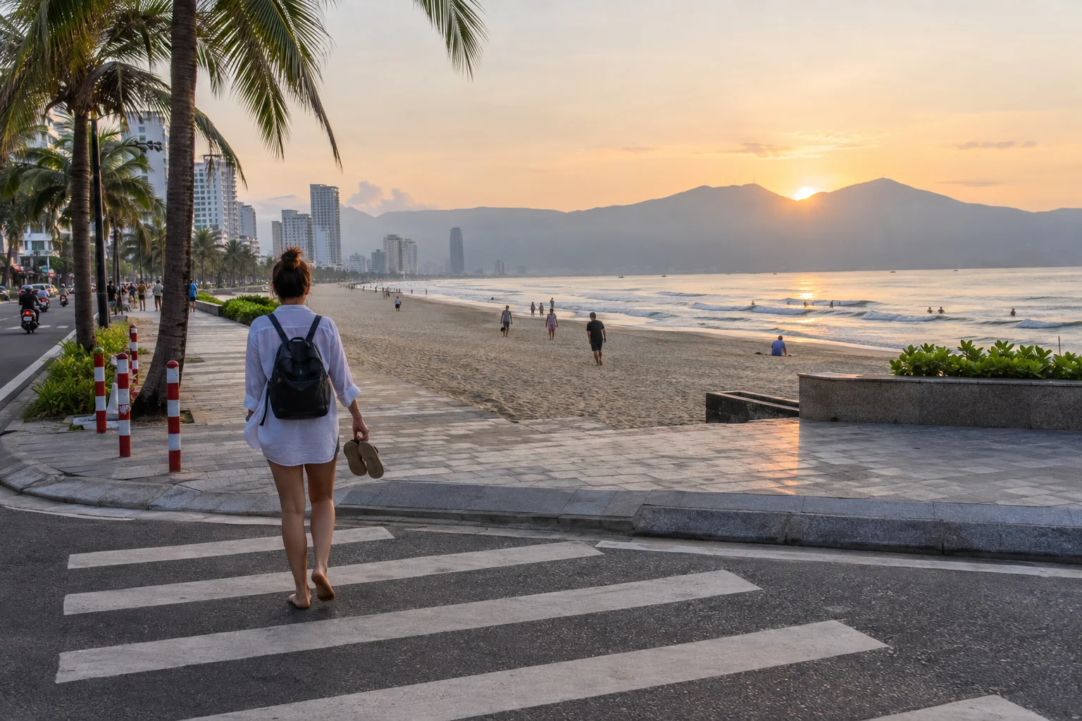 Traveler walking from a Da Nang hotel toward My Khe Beach at sunrise